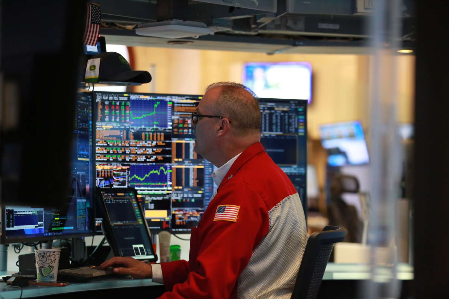A trader at a stock exchange terminal watching rate-sensitive markets